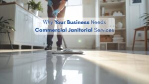 Professional janitorial worker cleaning office floors in a modern North American-style business space with natural sunlight.
