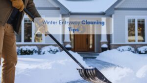 Man shoveling snow from a home entryway during winter, illustrating tips for keeping entrances clean and safe.