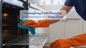 Woman cleaning an oven in preparation for Thanksgiving in a bright, organized kitchen of a modern American home.