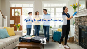 Spring break home cleaning in a bright living room as a professional wipes the mantel while a family packs suitcases for vacation, Paula's Cleaning Services serving NH, CT and MA.